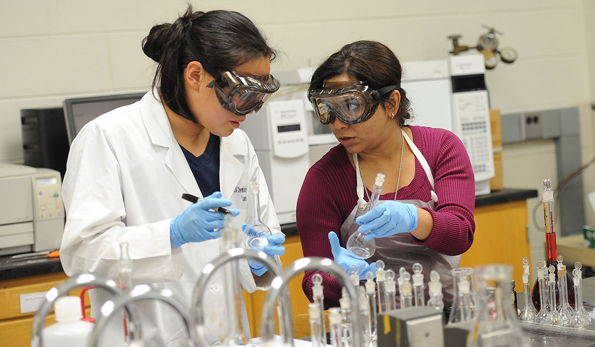 Two female students working in a lab
