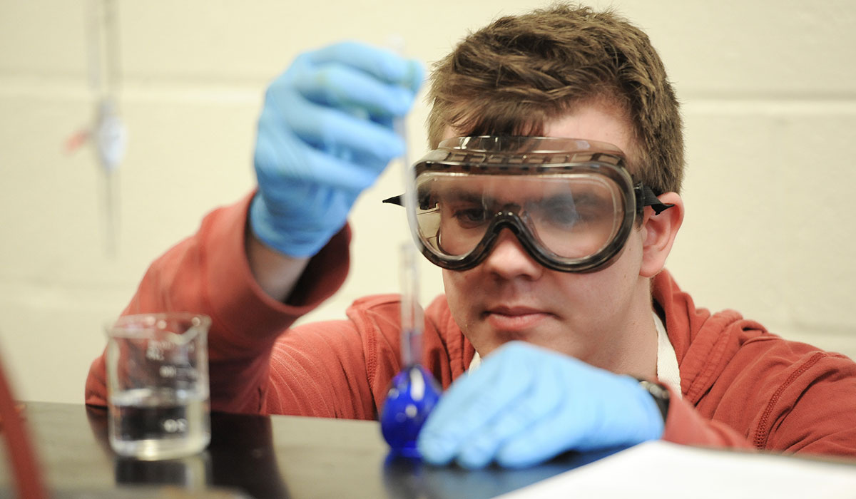 Student wearing googles working in lab